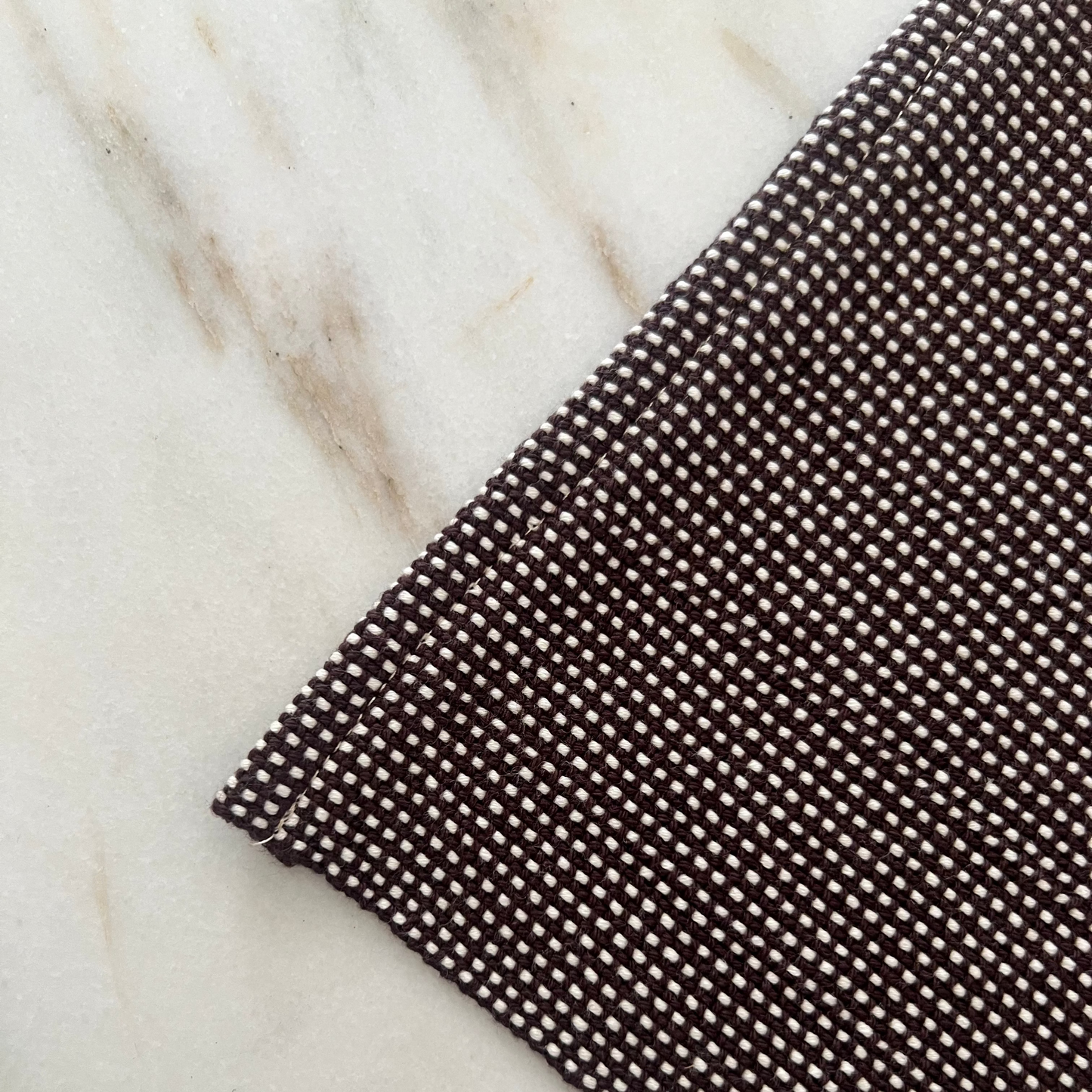 Brown textured mat on a marble surface