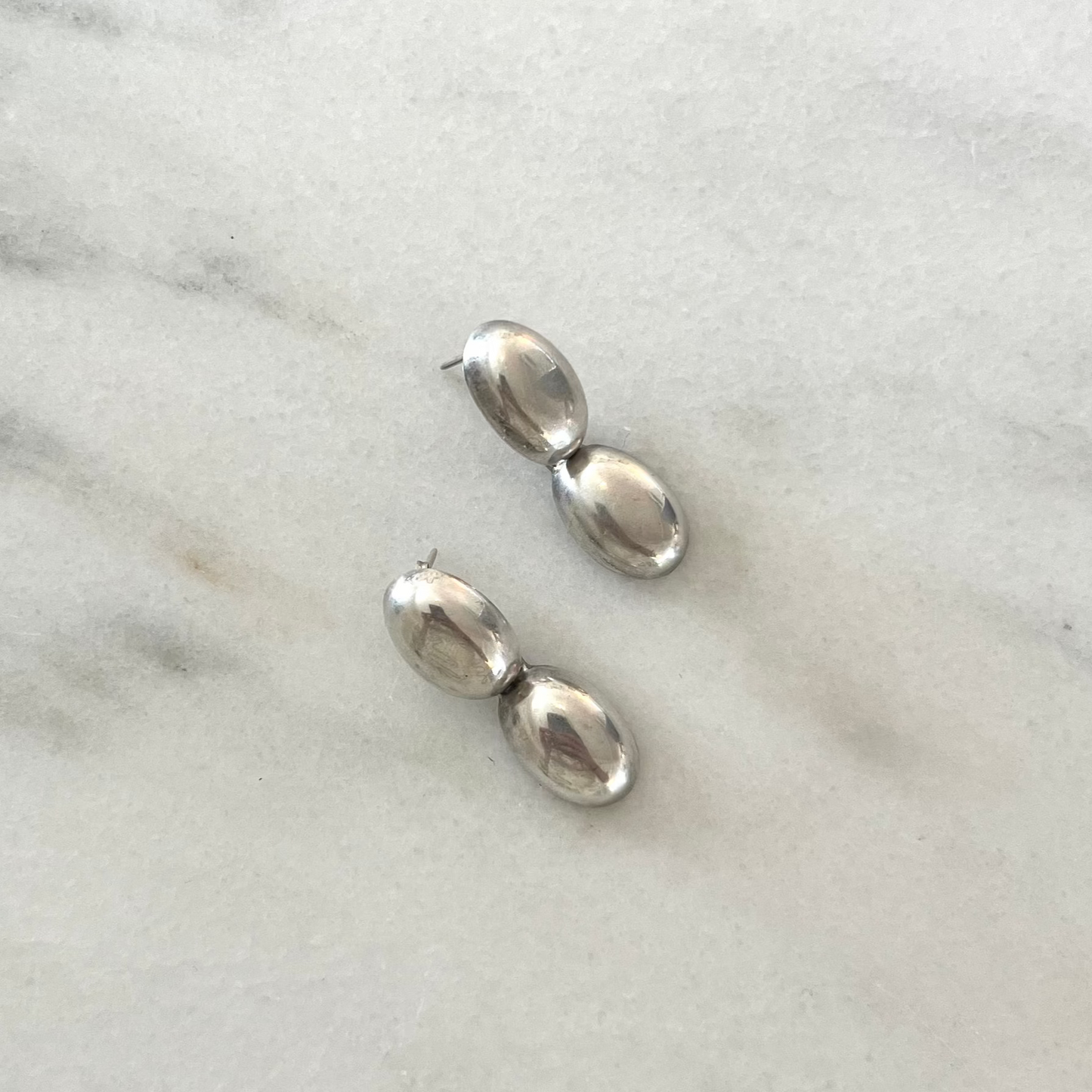 pair of silver dangle egg earrings