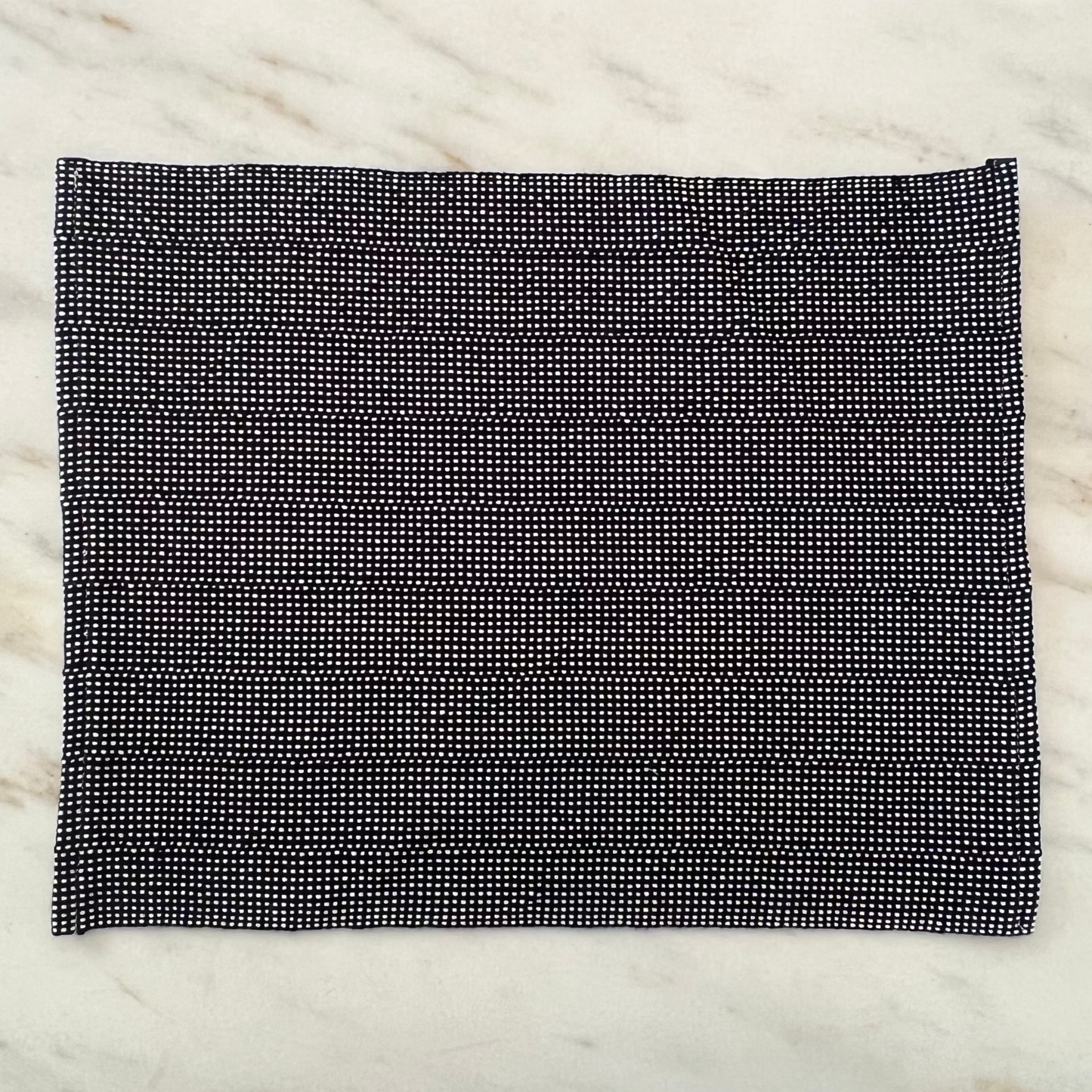 navy and white placemat on a marble surface