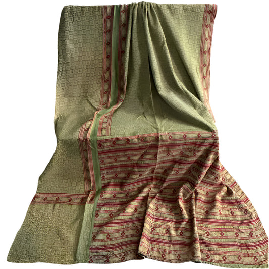 Traditional patterned fabric draped over a surface with a plain background