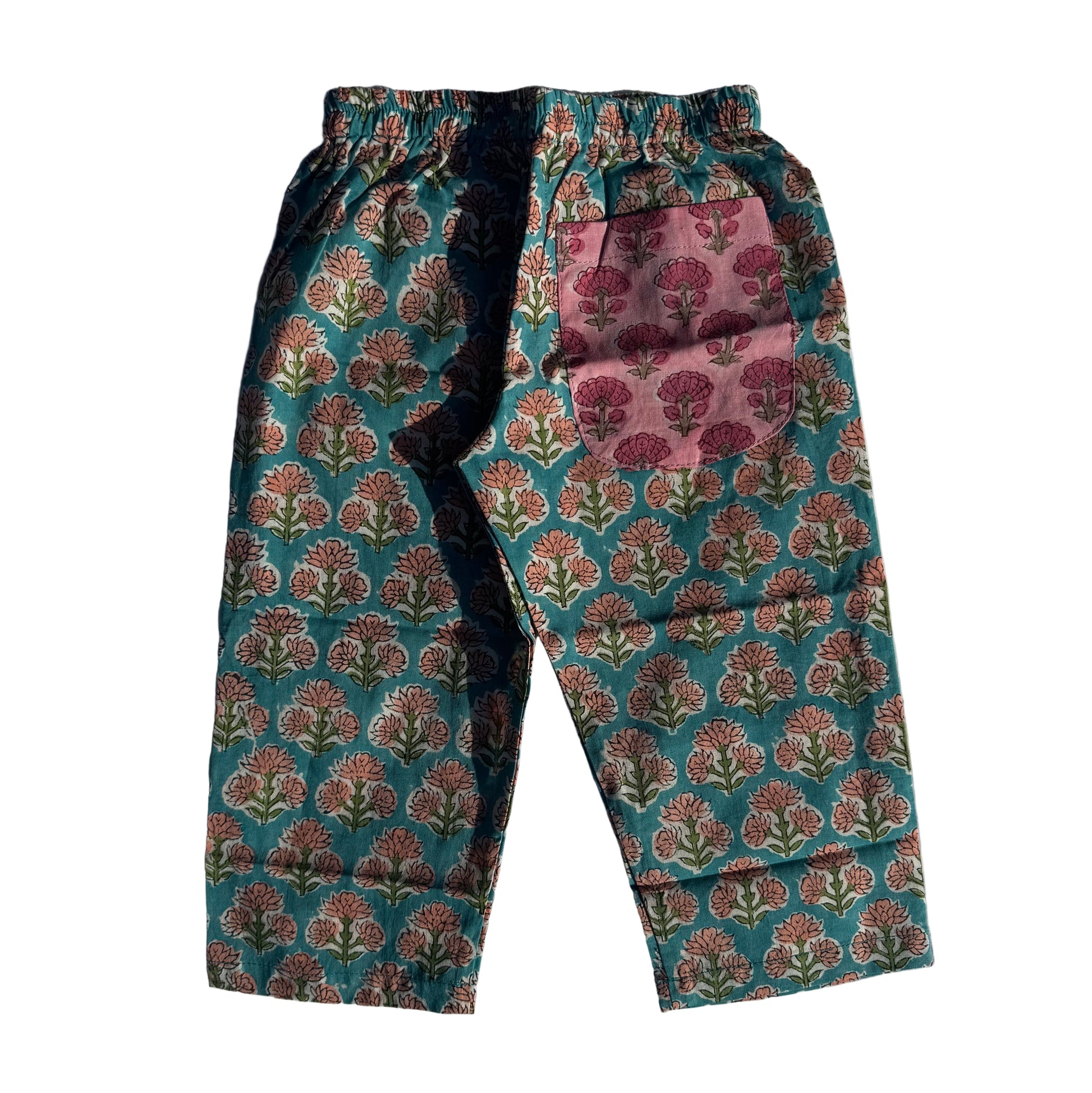 Floral-patterned pants on a white fabric background
