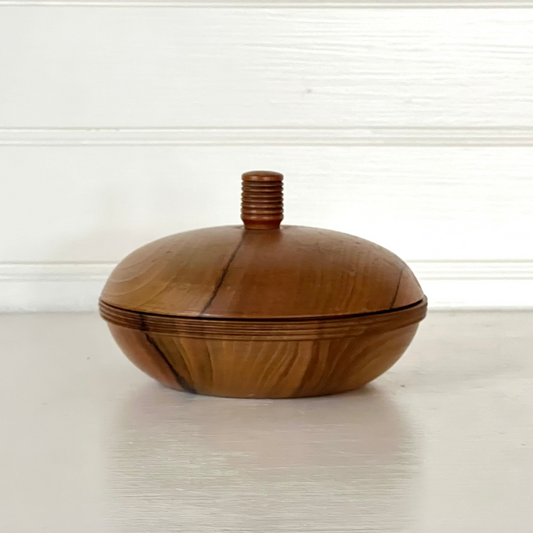 Wooden container with a lid on a white surface