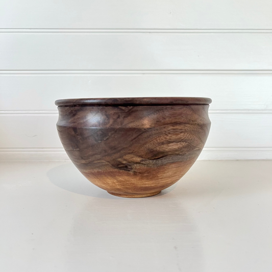 Wooden bowl on a white surface with a white background