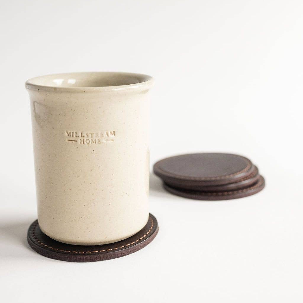 White ceramic tumbler with brown base and lid on a white background