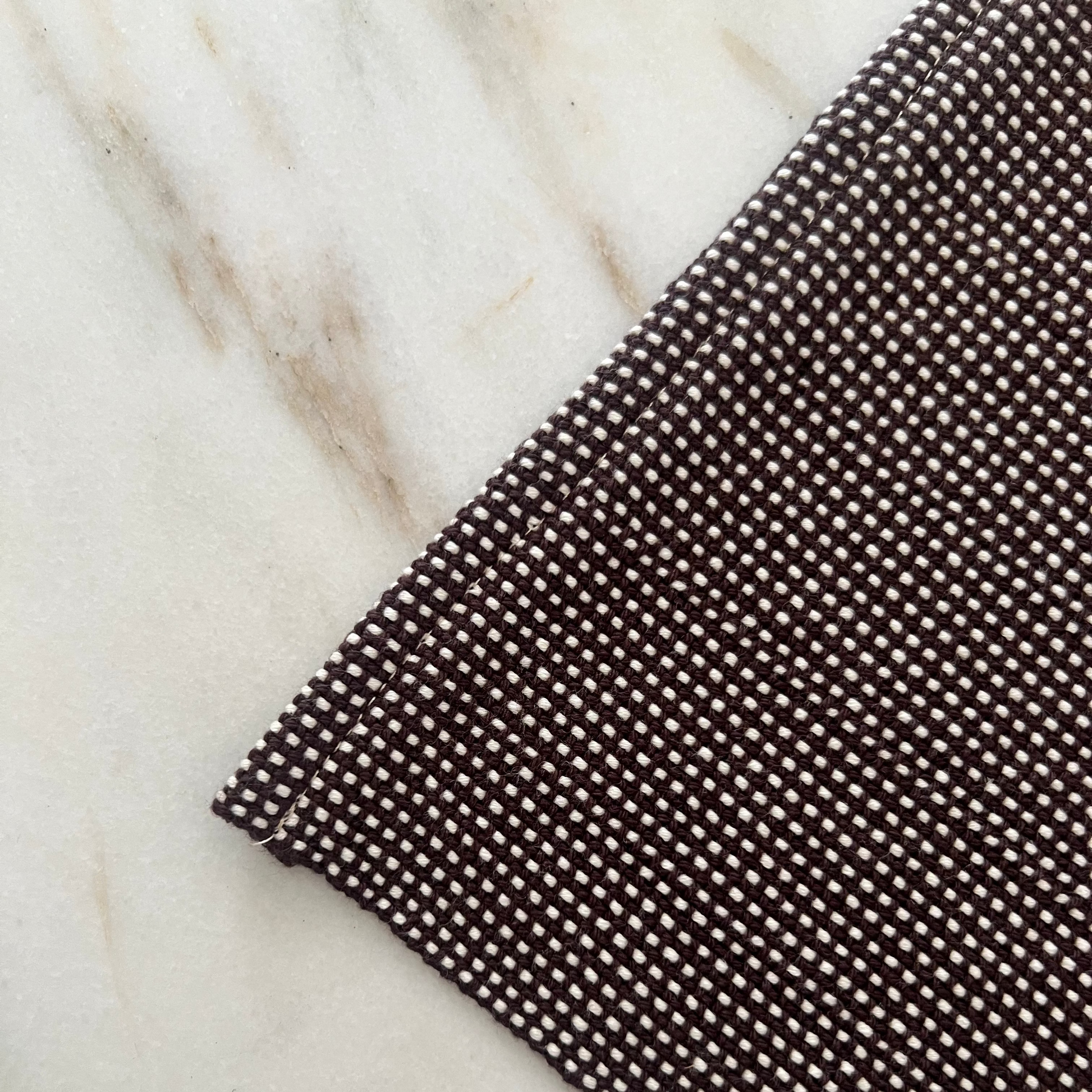 Brown textured mat on a marble surface