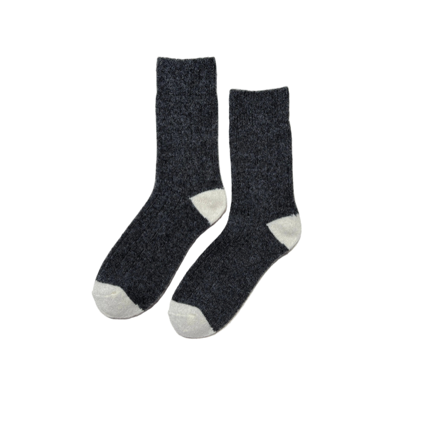 A pair of dark charcoal gray heathered wool socks with contrasting light gray toes and heels, displayed against a solid white background.