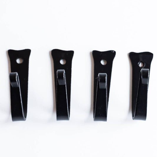 Four black wall hooks on a white background